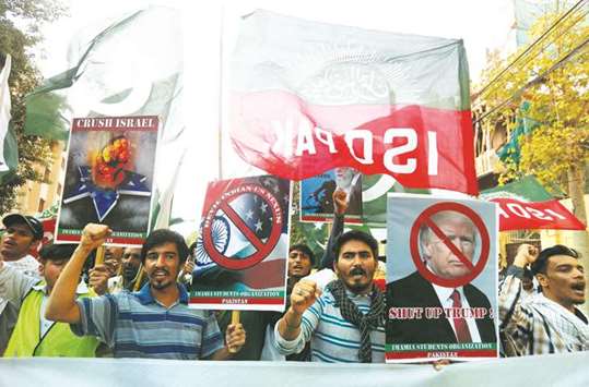 Supporters of Imamia Students Organisation (ISO) chant slogans and carry signs during a protest rally against US President Donald Trump, while marching towards the US consulate in Karachi.