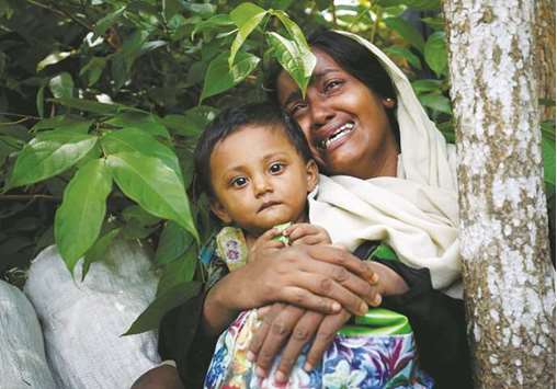 A Rohingya woman cries with her child, after being prevented from entering Bangladesh.