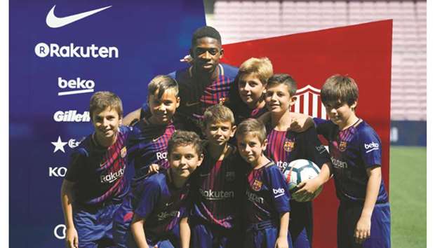 Barcelonau2019s new signing Ousmane Dembele poses with young fans at the Camp Nou stadium in Barcelona yesterday. (AFP)