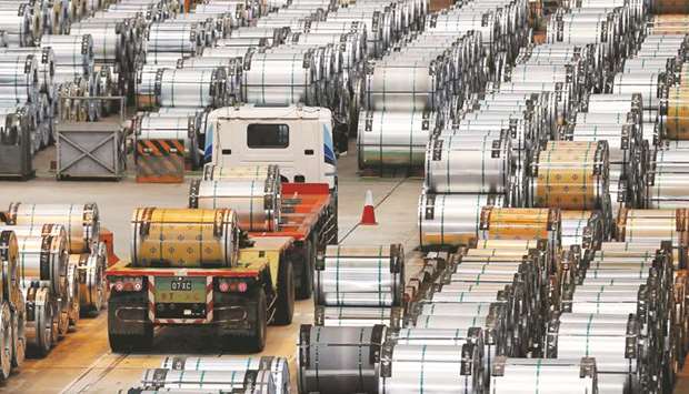 A truck drives past rolls of steel inside a factory in Shanghai. Chinau2019s official manufacturing Purchasing Managersu2019 Index (PMI) is expected to touch 51.3 for August, down just a hair from Julyu2019s 51.4, according to a median forecast of 39 economists polled by Reuters.