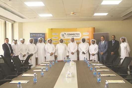 Q-Post and QCAA officials at the MoU signing ceremony.