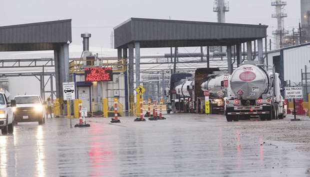 Tanker trucks enter the Marathon Petroleum Corporation refinery ahead of Hurricane Harvey in Texas City. Harvey hit the Texas shore as a fierce Category 4 hurricane, causing massive flooding that knocked out 11.2% of US refining capacity, a quarter of oil production from the US Gulf of Mexico.