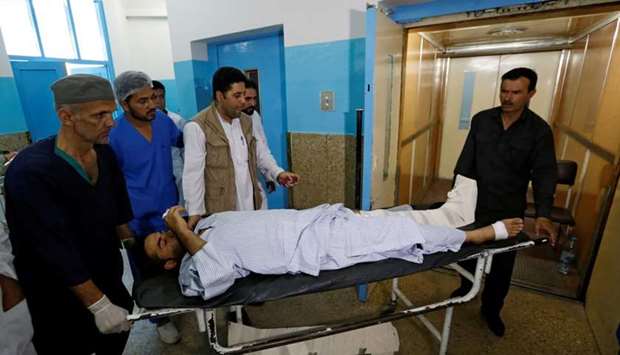 An injured man is carried inside a hospital after a suicide attack in Kabul, Afghanistan. Reuters 
