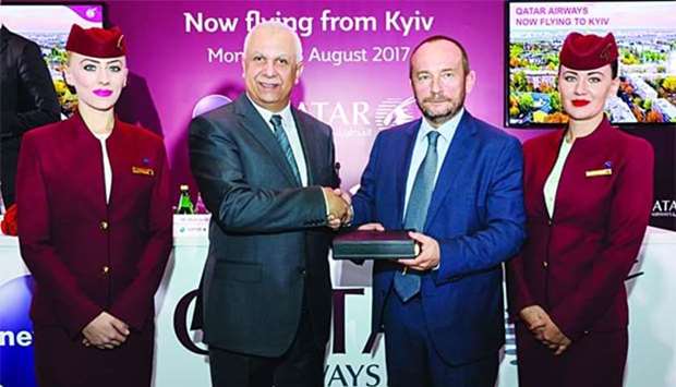 Boryspil International Airport CEO Pavlo Riabikin (second right) is seen with Qatar Airways'  chief commercial officer Ehab Amin in Kyiv.