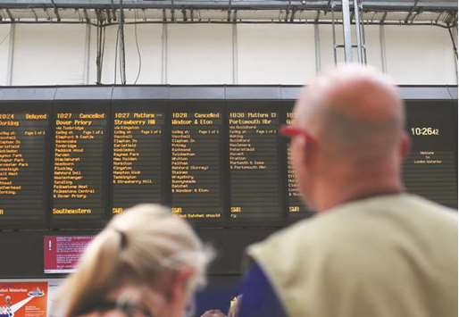 A notice board displays cancelled and delayed train journeys at Waterloo train station.