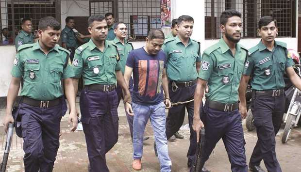 Bangladeshi security personnel escort Sohel Rana outside the court in Dhaka.