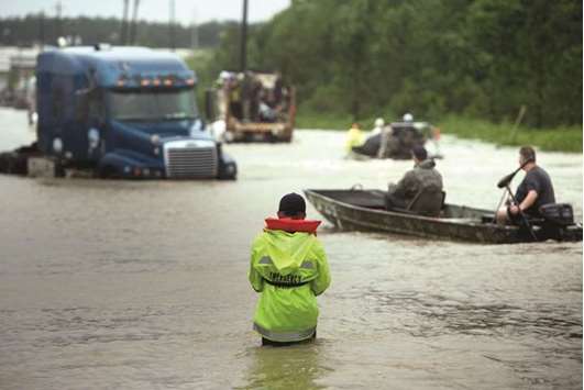 People make their way through a flooded street during the aftermath of Hurricane Harvey in Houston yesterday.