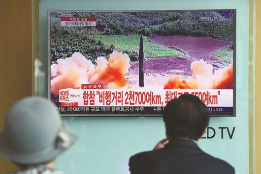 People watch a television news screen showing file footage of a North Korean missile launch, at a railway station in Seoul yesterday.