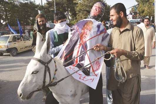A Pakistani demonstrator walks with a donkey carrying an effigy of US President Donald Trump during a protest in Quetta. Angry and offended Pakistanis fired back against Donald Trumpu2019s accusations that their country harbours militants, highlighting the heavy toll they have paid fighting extremism and slamming his embrace of arch-rival India.