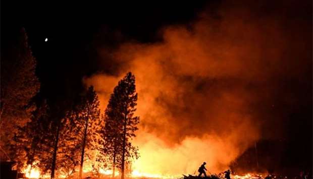 A firefighter battles the Ponderosa fire east of Oroville, California.