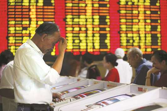 Investors look at computer screens showing stock information at a brokerage house in Shanghai. As equities from Seoul to Hong Kong were felled by Tuesdayu2019s North Korea-inspired wave of risk aversion, Shanghai was one of the few  benchmarks globally to rack up gains, driving home how much has changed in a market that was in the red as recently as two months ago.