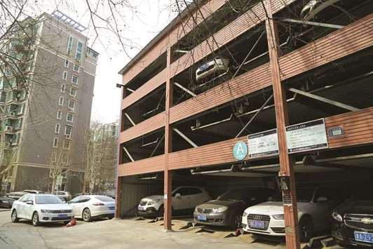 A multi-storey car park is seen next to an apartment building at a housing estate in Jinan, Shandong province. As if contending with sky-high homes prices wasnu2019t enough, some buyers are now forced to fork out as much as 1mn yuan ($151,821) for car parking spaces in major second-tier Chinese cities, such as Tianjin, Xiamen, Hangzhou, Nanjing and Suzhou.