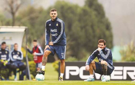 Argentinau2019s Mauro Icardi (left) and Lionel Messi take a breather during a training session in Buenos Aires, Argentina. (Reuters)