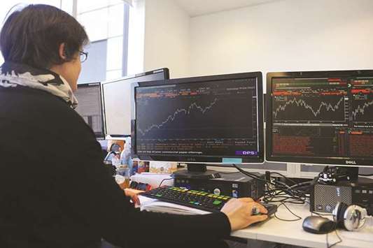 A trader works at the London Stock Exchange. The FTSE 100 closed 0.4% higher at 7,365.26 points yesterday.