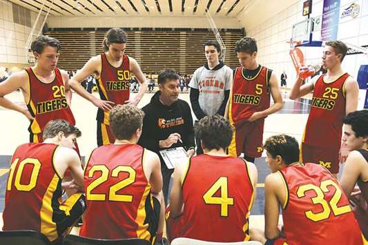 In this June 10, 2017, picture, former NBA player Mark Bradtke (centre) gives instructions to players, including his son Austin (back, second from left) during a basketball game on the outskirts of Melbourne. (AFP)