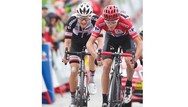 Team Skyu2019s British cyclist Christopher Froome (right) crosses the finish line of the 11th stage of Vuelta a Espana in Calar Alto, Spain, yesterday. (AFP)
