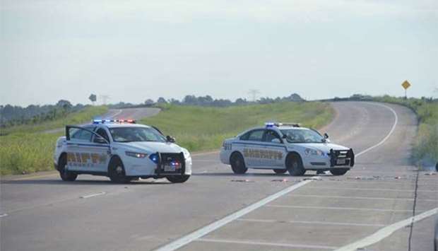 Harris County Sheriff vehicles block the Crosby Freeway leading towards the Arkema Chemical Plant in Crosby, Texas on Thursday.