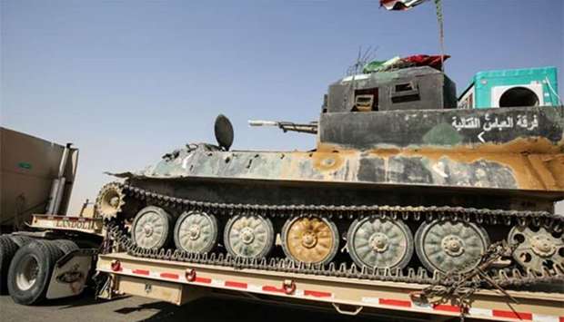 An Iraqi-modified Russian-made armoured personnel carrier is seen towed on a trailer departing the northern city of Tal Afar on Thursday after the Iraqi Prime Minister declared that government forces and thier allies had retaken the city and the surrounding region.