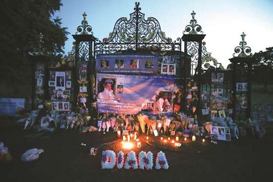 Floral tributes, candles and photographs left outside one of the entrances of Kensington Palace in London to mark the 20th anniversary of the death of Diana, Princess of Wales.