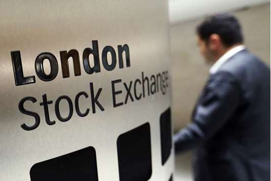 A visitor passes a sign inside the main atrium of the London Stock Exchange Group headquarters. London stocks closed 0.9% higher at 7,430.62 points yesterday.