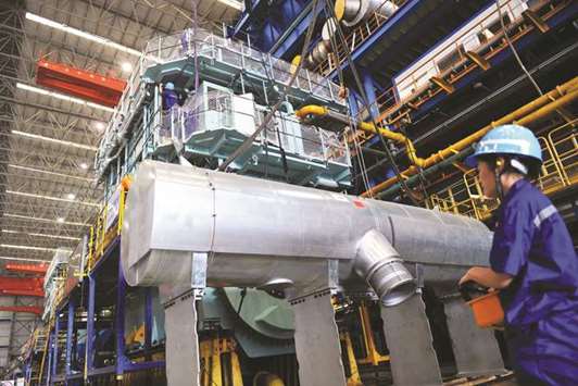 A worker looking at a diesel engine production facility at a factory in Qingdao, Shandong province. Chinau2019s factory activity gathered steam in August, official data showed yesterday, beating expectations, but not dispelling concerns about the headwinds facing the worldu2019s second largest economy.