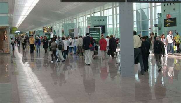 Visitors face lengthy queues at Barcelona's El Prat airport. 
