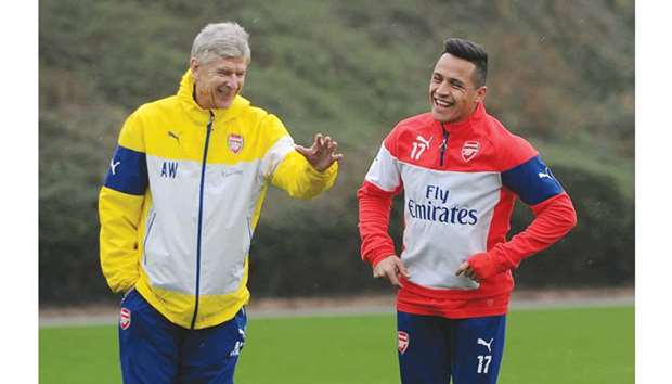 File picture of Arsenal coach Arsene Wenger (L) with his striker Alexis Sanchez during a training session.
