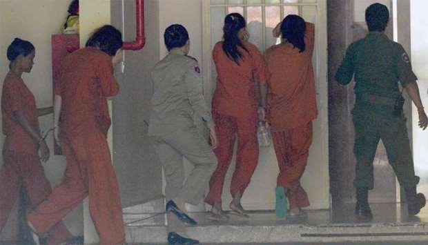 Australian national Tammy Davis-Charles (2nd L), seen with other detainees, is escorted by Cambodian