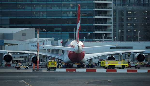 Fire engines position alongside a Qantas A380 aircraft after the Dallas-bound flight QF7 was forced to return and make an emergency landing due to mechanical fault at Sydney International Airport in Australia.