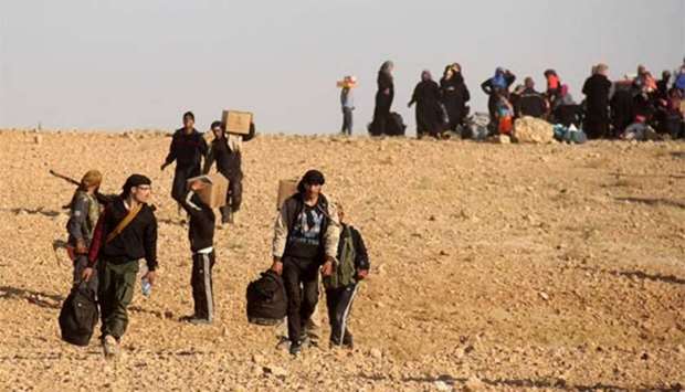 Syrian civilians and militants who were evacuated from northeastern Lebanon are seen after crossing into the rebel-held area of Al-Saan in the central Hama province.