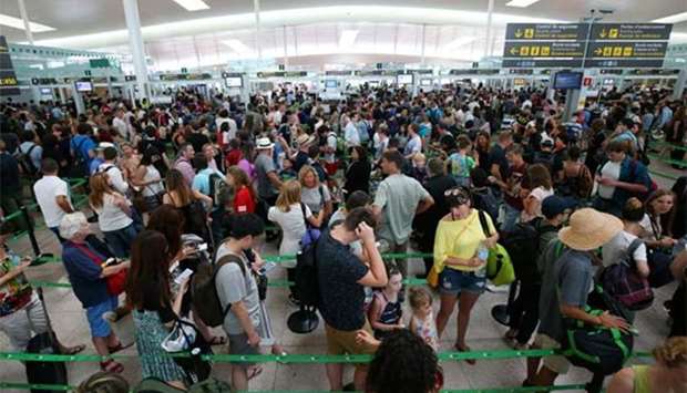 People queue at El Prat airport in Barcelona as security staff strike on Friday.