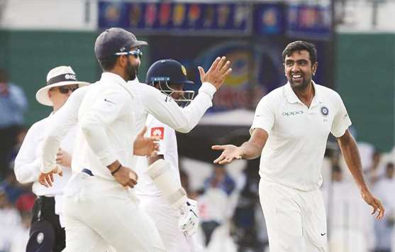India's off-spinner Ravichandran Ashwin (right) celebrates with his teammates after dismissing Sri Lankan batsman Upul Tharanga during the second Test in Colombo yesterday. (AFP)