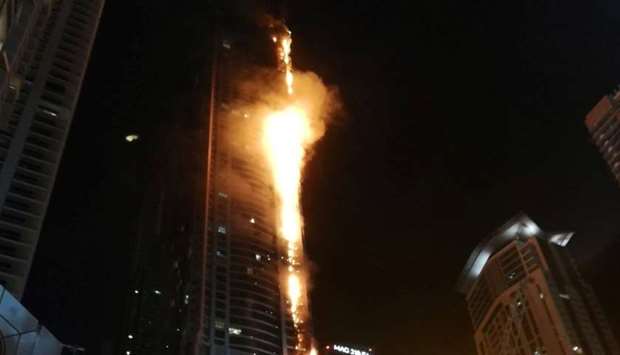 Flames shoot up the sides of the Torch tower residential building in the Marina district, Dubai, United Arab Emirates, in this August 4, 2017 picture by Mitch Williams