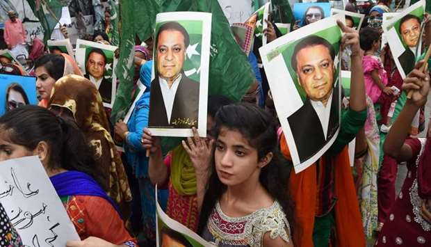 Supporters of ousted Pakistani Prime Minister Nawaz Sharif carry placards featuring his images during a demonstration in Karachi on August 3, 2017.