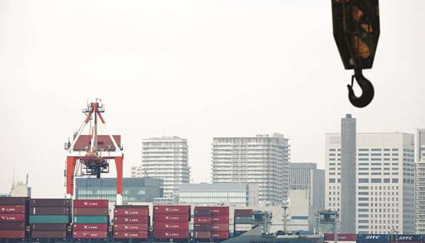 A cargo ship is seen at an industrial port in Tokyo. Japanu2019s gross domestic product is seen expanding at an annualised rate of 2.5% in the second quarter, a poll of 20 analysts found.