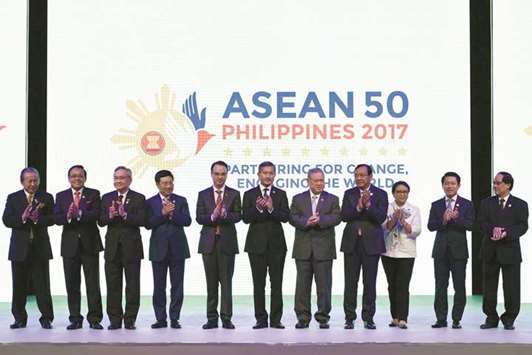 Asean foreign ministers and Secretary-General Le Luong Minh pose for a family photo during the opening ceremony of the 50th Association of Southeast Asia Nations Regional Forum meeting in Manila yesterday.