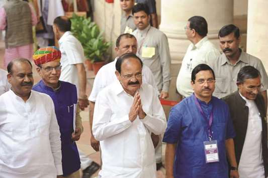 Venkaiah Naidu greets MPs ahead of voting in New Delhi yesterday.