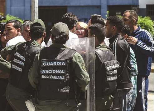 Venezuelau2019s chief prosecutor Luisa Ortega (centre) is surrounded by people and national guards during a visit yesterday to her office in Caracas. Venezuelau2019s contested new assembly has sacked her in a move sure to provoke greater international criticism.