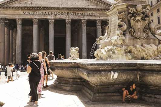 A girl shelters from the sun at the fountain of the Pantheon in the Piazza della Rotonda, central Rome, yesterday, as temperatures reached more than 40u00b0C.