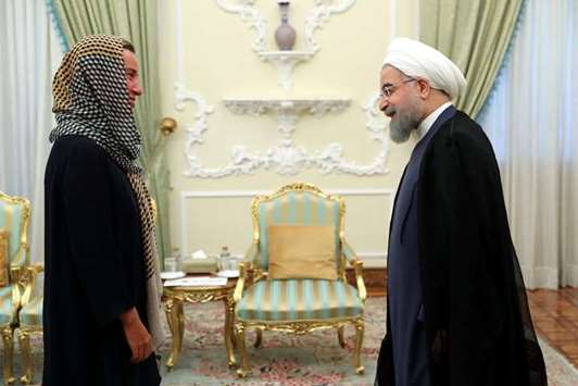 Iranian President Hassan Rouhani meets EU foreign affairs chief Federica Mogherini in Tehran yesterday.