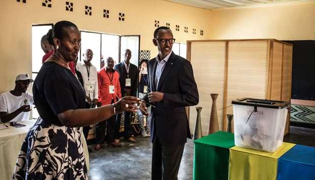 Incumbent Rwandan President Paul Kagame and his wife Jeannette arrive to cast their vote at a polling station in Kigali, yesterday