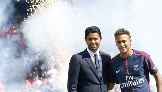 Paris Saint-Germainu2019s Brazilian forward Neymar (R) poses with Paris Saint-Germainu2019s (PSG) president Nasser al-Khelaifi (L) during his presentation to the fans at the Parc des Princes stadium in Paris yesterday.
