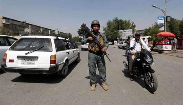 An Afghan police officer inspects vehicles at a checkpoint in Kabul on Sunday.
