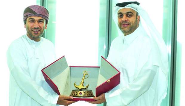 Captain Abdulla al-Khanji (right) presenting souvenir to a senior Omani official