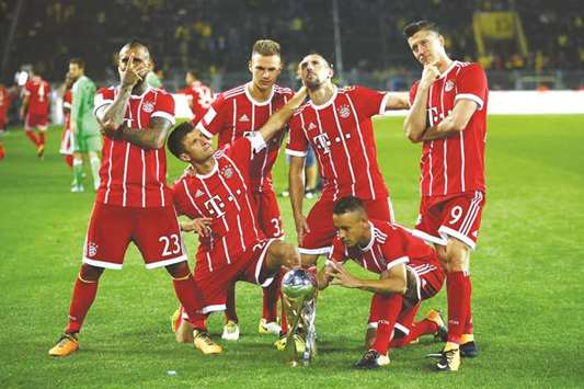 Bayern Munich players celebrate with the trophy after winning the DFL-Supercup.