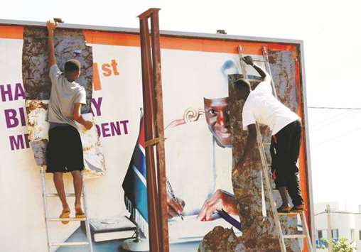 This picture taken on December 4 last year shows people tear a poster of Jammeh in Broussbi.