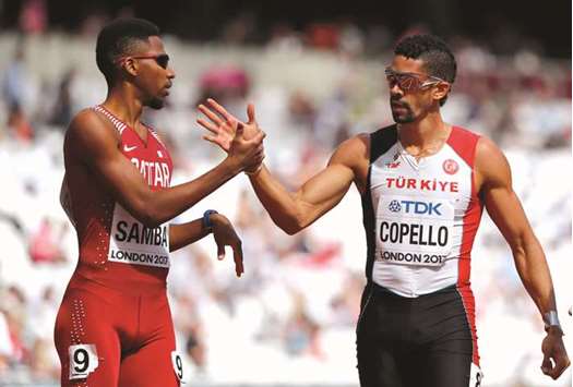 Qataru2019s Abderrahaman Samba (left) and Turkeyu2019s Yasmani Copello congratulate each other on finishing the menu2019s 400m hurdles heat London yesterday. (Reuters)