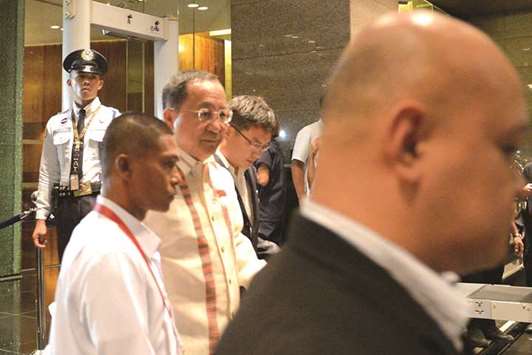 North Koreau2019s Foreign Minister Ri Yong-ho, dressed in traditional Filipino u2018barongu2019 is flanked by security as he leaves his hotel ahead of the gala dinner of the 50th Association of Southeast Asian Nations (Asean) regional security forum in suburban Manila.