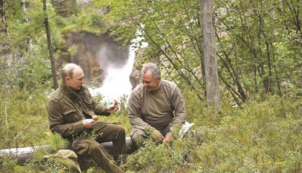 Putin shows mushrooms to Shoigu during his vacation in the remote Tuva region in southern Siberia. The picture taken between August 1 and 3.