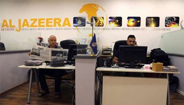 Employees are seen inside the Al Jazeera office in Jerusalem on Monday.